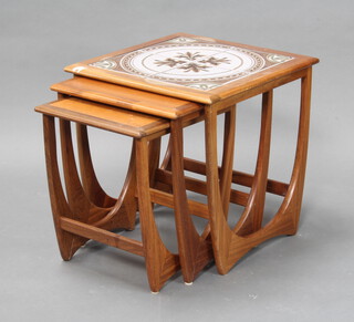 A nest of 3 1950's G-Plan style teak "Astro" coffee tables, the largest with tiled top 51cm h x 50cm w x 50cm d (some water marks)