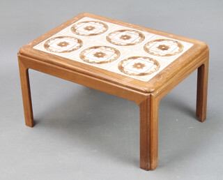 A rectangular teak tiled top coffee table on square supports 39cm h x 71cm l x 50cm w (some water damage)