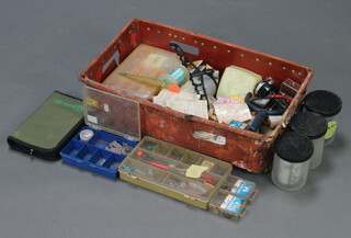 A large collection of coarse and pike fishing tackle including floats, weights etc, contained in a red crate
