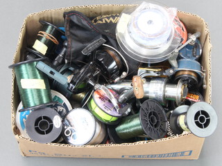 A collection of carp fishing reels and match reels including Mitchell 440 Match, Shakespeare close face match and a collection of Daiwa, Berkley and other bulk spools and spare reel spools, contained in a box 
