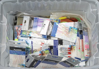 A collection of fly fishing tackle including boxes for flies, lines, scales, sea fishing rigs for mackerel, cod, pollock and sea bass, etc contained in a plastic box
