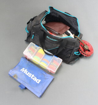 A collection of fishing tackle contained black cloth holdall 
