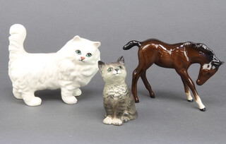 A Beswick figure of a cat 13cm, a Royal Doulton figure of a cat 9cm together with a Royal Doulton gloss figure of a horse 11cm 