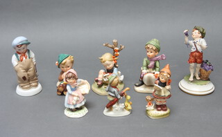 A Goebel figure of a seated boy playing a horn 10cm and 7 other Continental porcelain figures