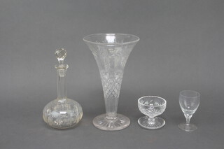 A cut glass flared necked vase 30cm, a spirit decanter, 4 cut glass sundaes, 5 moulded sundaes, 7 medium wines, 6 large wines, a pedestal bowl and a glass