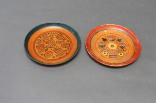 A pair of turned wooden and painted dishes, the reverse marked Festival Budapest 