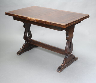 An oak refectory style draw leaf dining table, raised on standard end supports with H framed stretcher 78cm h x 114cm x 71cm  