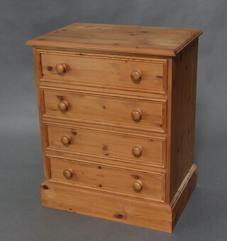 A Victorian style pine chest of 4 long drawers raised on a platform base 87cm h x 71cm w x 48cm d 