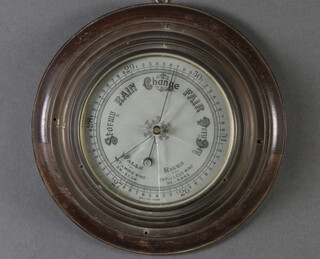 An aneroid barometer with silvered dial, contained in a gilt metal case 4cm x 27cm diam. (glass cracked)