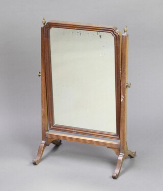 A 19th Century arched plate dressing table mirror contained in a mahogany swing frame 62cm x 39cm x 25cm (signs of deterioration to the silvering on the mirror) 
