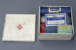 A vintage first aid kit contained in a metal tin 14cm h x 22cm w x 23cm d 