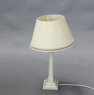 A square white painted table lamp of waisted form, raised on a square foot 37cm h x 13cm w x 13cm d 
