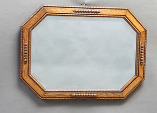 A 1930's lozenge shaped bevelled plate wall mirror contained in an oak frame 48cm h x 66cm w