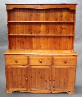 A pine dresser, the raised back fitted 2 shelves above 3 drawers and triple cupboard 176cm h x 139cm w x 42cm d 