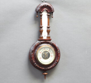 An aneroid barometer and thermometer contained in a carved walnut wheel shaped case (finial to top missing) 50cm x 20cm 