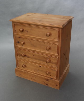 A Victorian style pine chest of 4 long drawers with tore handles on a platform base 87cm h x 71cm w x 48cm d 

