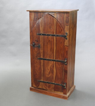 A hardwood cabinet enclosed by arched panelled doors with iron hinges, raised on a platform base 120cm h x 60cm w x 36cm d (water damage to the top) 
