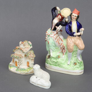 A Victorian Staffordshire group of a couple with goat 24cm, a ditto cottage 11cm and a reclining sheep 6cm (the first figure is restored)