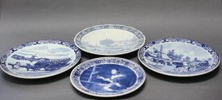 A Delft charger decorated with a figure of a lady 33cm and 3 others