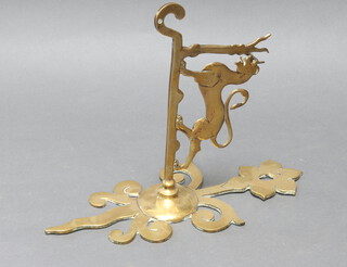 A brass spit jack bracket with griffin decoration 