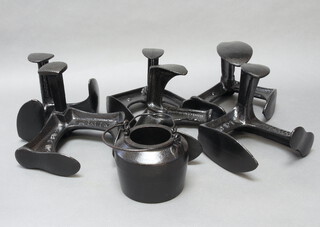 Six black painted Victorian shoe lasts and a black painted glue pot with swing handle 