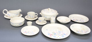 A quantity of Poole Springtime dinnerware comprising 6 coffee cups and saucers, 7 tea cups and 8 saucers, 8 small plates, 7 side plates, 7 dinner plates, 2 casseroles, 6 dessert bowls, 7 soup bowls, sauce boat and stand , 1 condiment, 5 egg cups, 6 deep bowls, a pie dish 