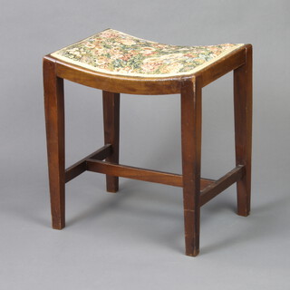 A 1930's oak saddle shaped dressing table stool on square tapered supports with H framed stretcher 49cm h x 46cm w x 35cm d 