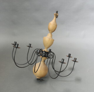 A turned beech and wrought iron 8 light candle chandelier 85cm x 82cm (slight split to one turning) 