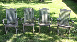 Alexander Rose, a set of 4 well weathered slatted wooden garden armchairs raised on square supports 105cm h x 62cm w x 40cm (seat 36cm x 32cm) 
