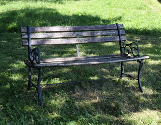 A well weathered metal and wooden slatted garden bench 69cm h x 124cm w x 38cm d (seat 101cm w x 36cm d)