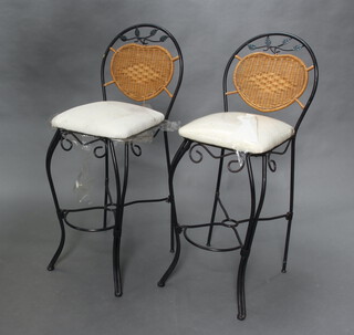 A pair of iron and wicker high back stools, raised on wrought supports 109cm h x 39cm w x 40cm d (28cm w x 32cm d) 