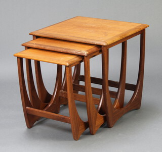 A nest of three teak Astro style interfitting coffee tables on swept supports 50cm h x 50cm w x 50cm d