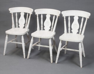 A set of 3 white painted Windsor style stick and rail back dining chairs 