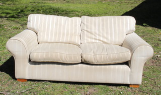 A sofa upholstered in white striped material 58cm h x 97cm w x 39cm d (some light staining in places) 