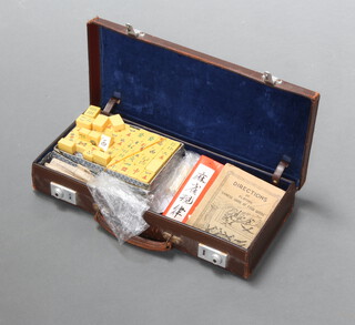 A leather attache case containing mahjong sets 