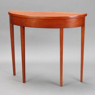 A narrow mahogany demi-lune table raised on square tapered supports 79cm h x 90cm w x 27cm d 
