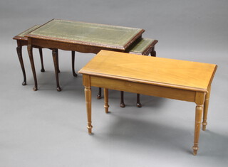A rectangular nest of 3 mahogany interfitting coffee tables with inset leather and glass tops together with a rectangular cherry "piano" stool with hinged lid