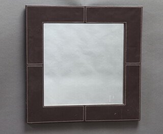 A rectangular plate wall mirror contained in a brown leather frame 69cm  x 69cm 
