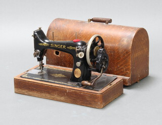 A Singer manual sewing machine no.Y6938903 complete with carrying case (the case has a hole and there is no key) 