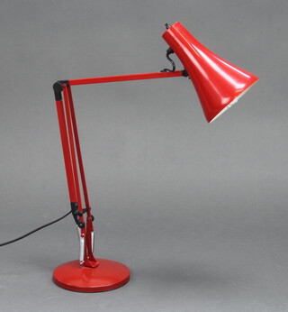 A 1970's red painted anglepoise table lamp, raised on a circular base 76cm high x 18cm diam. base 
