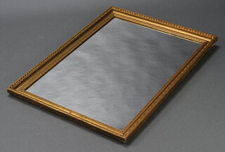 A rectangular plate wall mirror contained in a decorative gilt frame 99cm h x 72cm w 