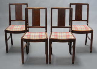 A set of 4 1930's oak slat back dining chairs with upholstered drop in seats, raised on square supports 