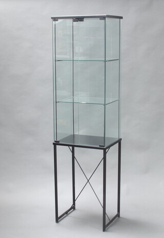 A pedestal display cabinet raised on ebonised tubular metal base 170cm h x 46cm w x 36cm d 