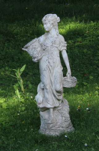 A well weathered reconstituted stone garden figure of a standing girl with baskets, raised on a circular base 65cm h x 20cm diam.  