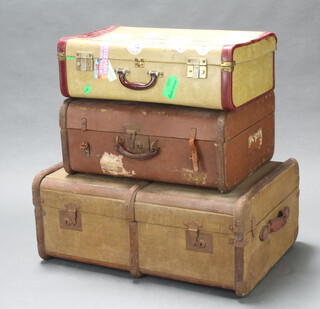 A fibre bound and wooden cabin trunk with LNSR label 32cm h x 76cm x 54cm (1 leather handle damaged), a fibre suitcase 26cm x 59cm x 46cm  (1 strap damaged), 1 other with numerous luggage labels including British Airways etc 19cm x 61cm x 38cm 