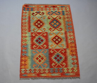 An orange, turquoise and green ground Chobi Kilim, the central ground formed of 6 rectangular panels 133cm x 88cm 