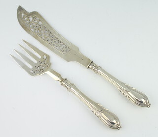 A pair of Victorian silver fish servers with lily pattern handles London 1870