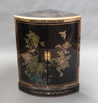 A 20th Century Chinese black lacquered bow front corner cabinet fitted a shelf with floral decoration 89cm h x 51cm w x 50cm d 