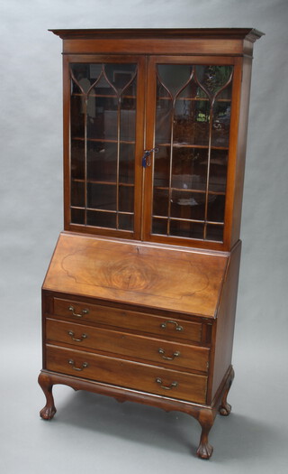 An Edwardian inlaid mahogany bureau bookcase, the upper section with moulded cornice, fitted shelves enclosed by astragal glazed panelled doors, the base with fall front above 3 long drawers, raised on cabriole ball and claw supports 201cm h x 91cm w x 48cm d 