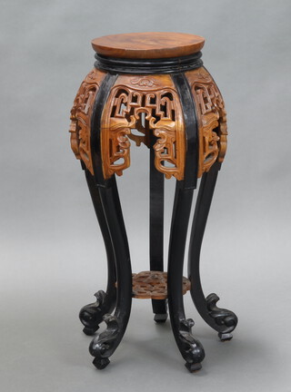 A Chinese pierced and carved hardwood and ebonised jardiniere stand, raised on cabriole supports 85cm h x 29cm diam. 